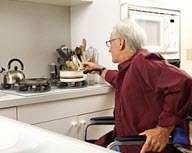 photo of elderly man in wheelchair at his kitchen counter top